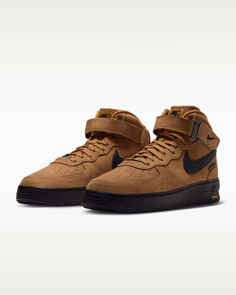 Par de Nike Air Force 1 Mid GORE-TEX Vibram color trigo sobre fondo blanco, con Swoosh negro y suela negra