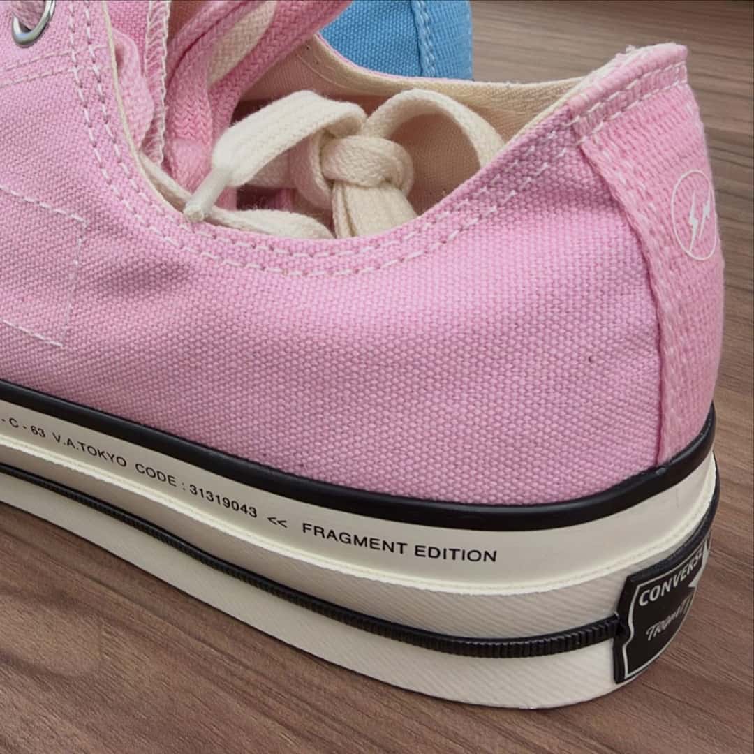 Detalle lateral de la Converse Chuck Taylor baja de fragment design rosa, con el rayo de fragment en el talón y la inscripción V.A.TOKYO y FRAGMENT EDITION en la entresuela